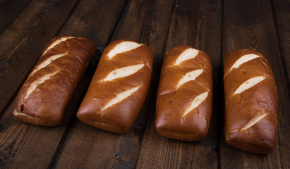 Freshly baked pretzel bread over wood background