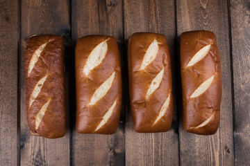 Freshly baked pretzel bread over wood background