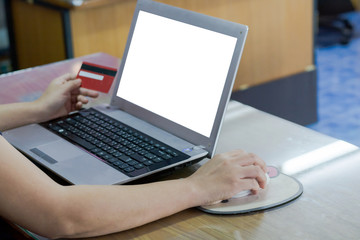 woman hand holding credit card and using laptop computer. Online shopping concept