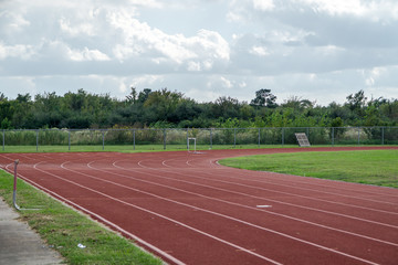 Track and field red clay at a high school stadium  