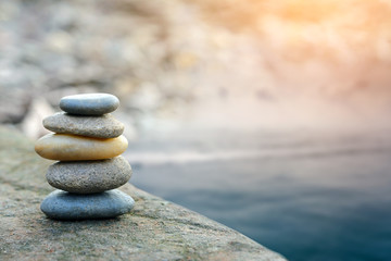 Balance stone with spa on river coast