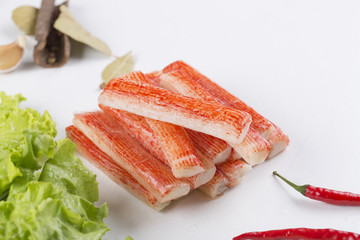 Red crab stick with green lettuce and coriander, pepper and other spices.