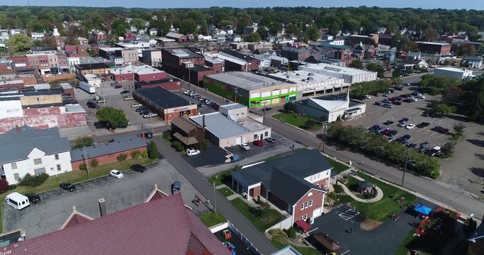 A day slow forward aerial establishing shot of the small town of Salem, Ohio's business district.  	