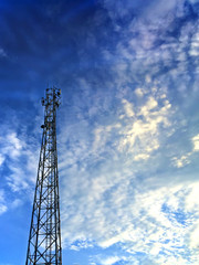 Communication Tower in Cloudy Sky