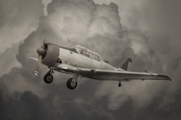 vintage propeller airplane on cloudy sky background