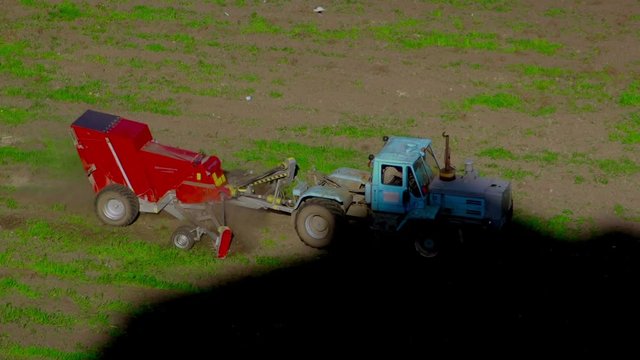 Tractor At Work. birds are flying behind the tractor. Aerial view