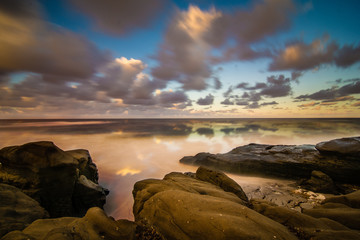 Reflections on the Pacific ocean at sunrise in San Diego, California