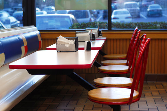 Table and seats inside fast food restaurant 