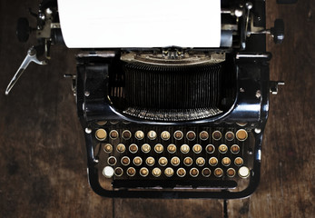 Vintage style typewriter on a wood desktop