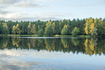Lake in Riga, district Jugla. Autumn, yellow tree leaves, lake and reflection. 2017