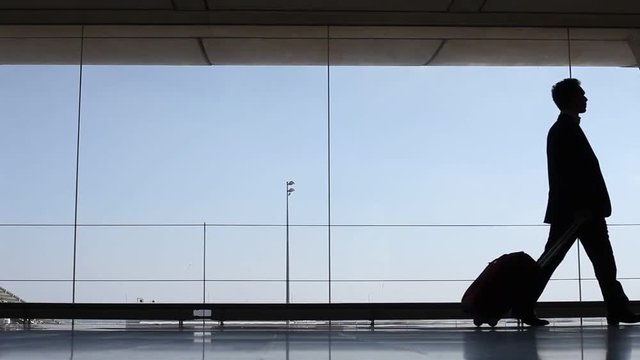 Passenger walking to the boarding gate in airport, business trip