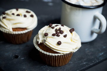 Cupcakes on the rustic wooden background. Shallow depth of field.