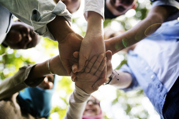 Group of diverse youth with teamwork joined hands