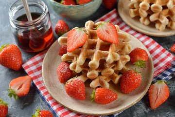 Waffles with maple syrup and strawberries