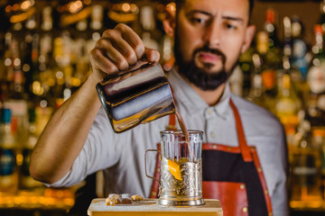 The bartender making cocktail