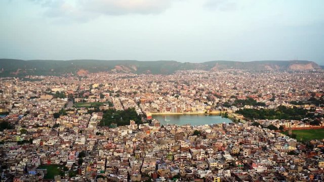 Panning shot of Jaipur city shot from the Nahargarh fort, show the famous govind dev temple and lake, the old walled city and many more of the famous easily identifiable landmarks