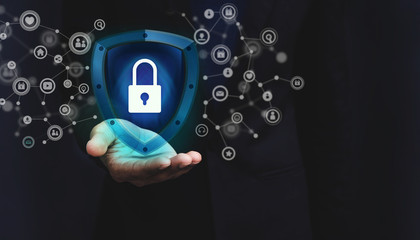 Network Security System Concept, Locked Key inside a Shield Guard to Protected Identify or Personal Information from Cyber Attacks, Present over Businessman Hand and Social Media icons