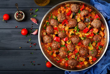 Meatballs in tomato sauce and vegetables in stew-pan