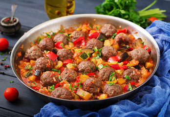 Meatballs in tomato sauce and vegetables in stew-pan