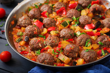Meatballs in tomato sauce and vegetables in stew-pan