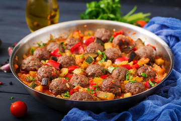 Meatballs in tomato sauce and vegetables in stew-pan