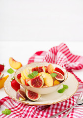 Vegan salad with figs, peaches, pears and strawberries