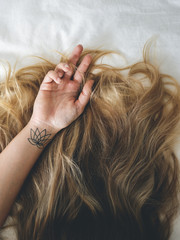 Obraz premium Woman with Brunette Hair Lying Down on the Bed