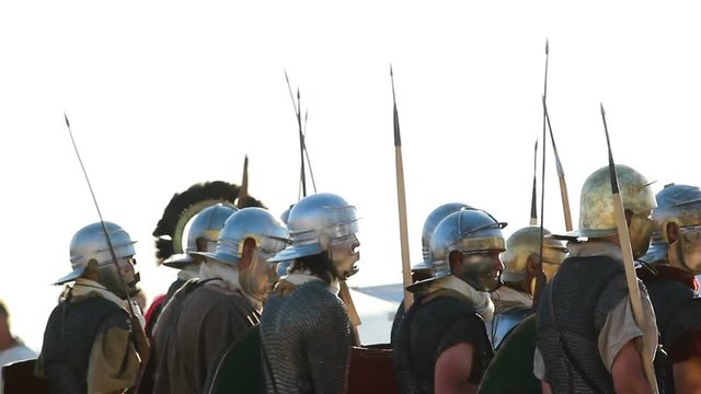 attack row of the ancient roman soldiers in helmets with spears