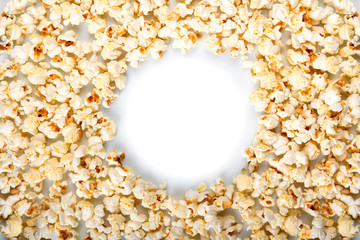 Round frame made of popcorn isolated on white.