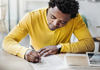 African descent man is filling an application