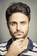 Headshot of smart guy isolated in grey background