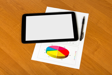 Tablet, pen and sheet of paper with graph on the desktop background.