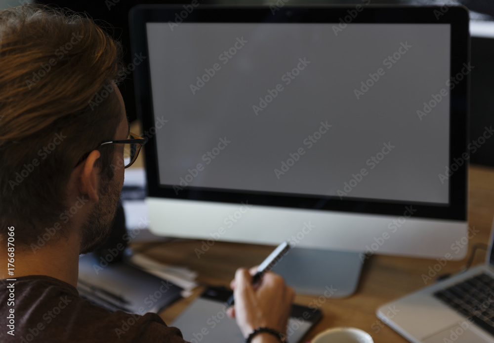 Poster man editing photos on a computer