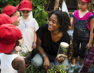 Teacher and kids having fun learning about plants