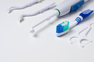 Dental oral irrigator, toothbrush, dental floss. On a white background
