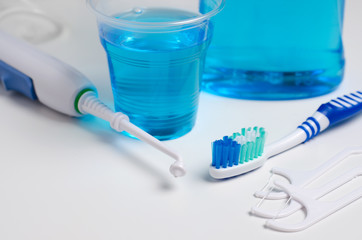 Dental oral irrigator, toothbrush, dental floss, mouthwash. On a white background