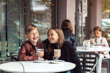 Children having fun in outdoor cafe