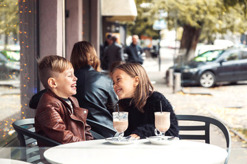 Children having fun in outdoor cafe