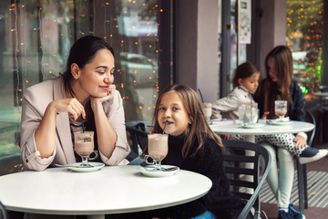 Family having fun in outdoor cafe