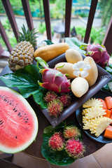 Exotic fruits, juicy, natural filming. Mango, papaya, dragon fruit, rambutan, pineapple
