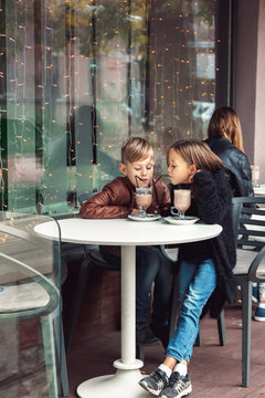 Children having fun in outdoor cafe