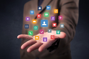 Businessman holding colorful applications
