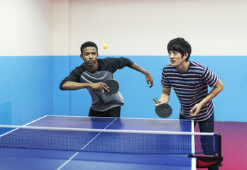 Friends playing table tennis