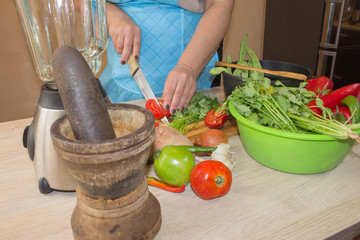 Young Woman Cooking in the kitchen. Healthy Food. Cropped image of young girl cutting vegetables for Food