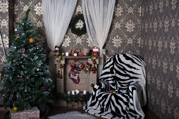 Beautifully decorated room with fireplace and Christmas tree for Christmas and New Year.  Winter card.