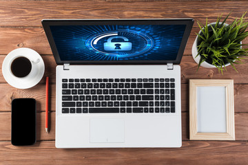 Web security and technology concept with laptop on wooden table