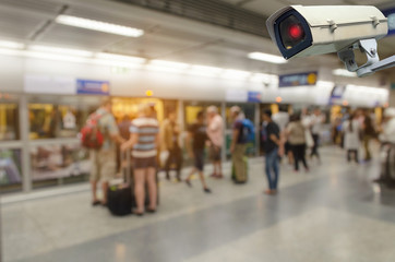 CCTV, security camera system operating with people waiting subway at train station, surveillance...
