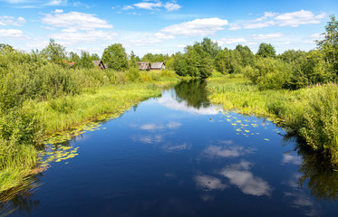 Fototapeta na wymiar Beautiful summer landscape with small tranquil river in northern Russia in sunny summer day