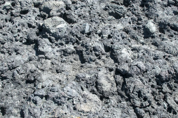 Sea rock of volcanic origin surface closeup as natural background