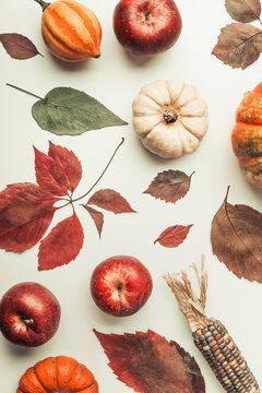 Autumn flat lay composing with pumpkin, apples and fall leaves , top view